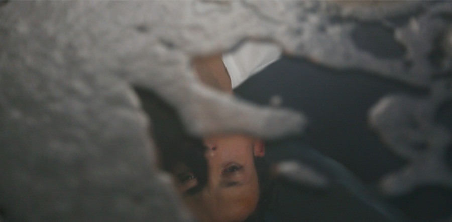 Giulia Cneci, If you want me again look for me under your boot-soles (wet grey), still da video, 2013 - Courtesy SpazioA - Pistoia